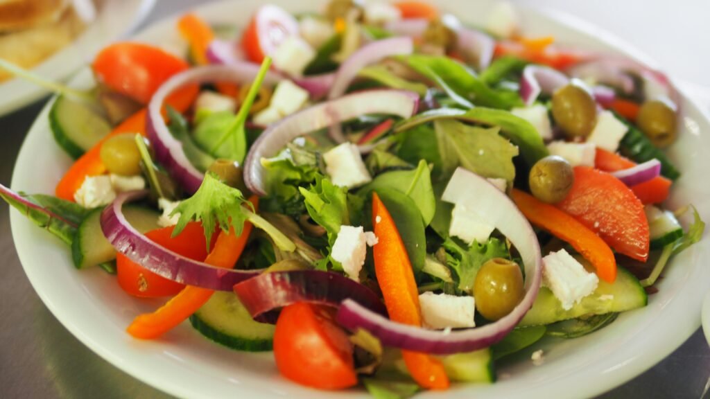 A vibrant Mediterranean salad featuring fresh vegetables, olives, and feta cheese for a healthy meal.